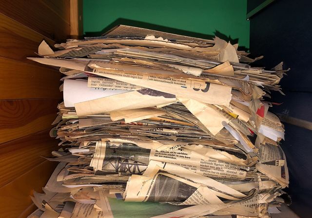 Clipping pile of articles from daily newspapers.